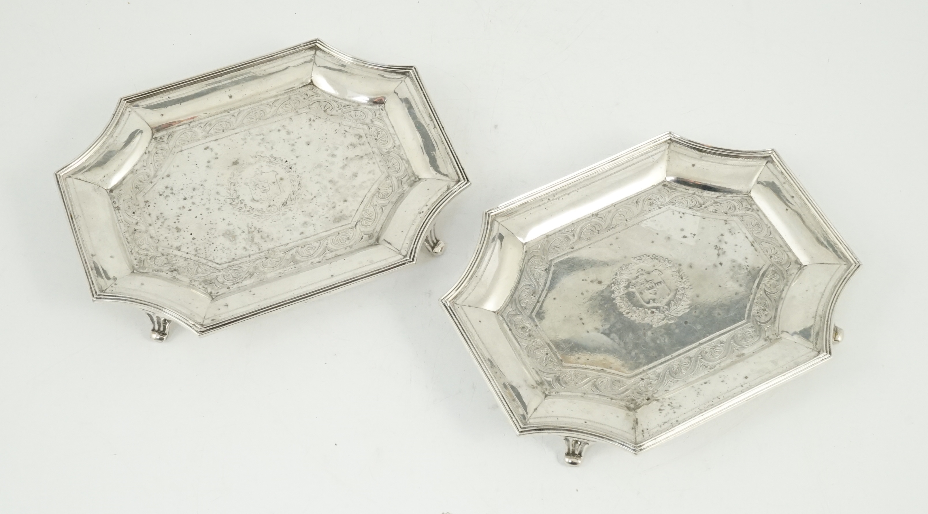 A pair of late Victorian engraved silver teapot stands, by Hunt & Roskell (ex Storr & Mortimer)